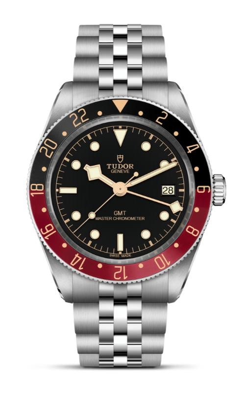 A luxury TUDOR GMT watch with a silver bracelet, black dial, and red-and-black bezel.
