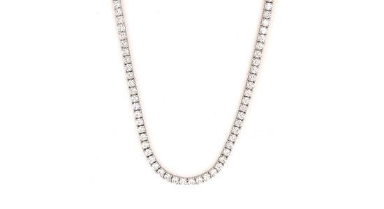a silver tennis necklace with a row of numerous round cut diamonds.