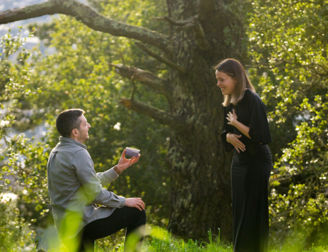 Jesse on one knee proposing to Kat atop Panoramic Hill