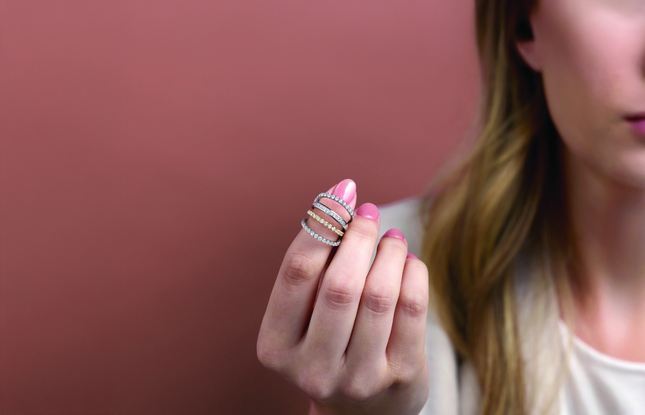 Four diamond bands displayed on a woman’s finger
