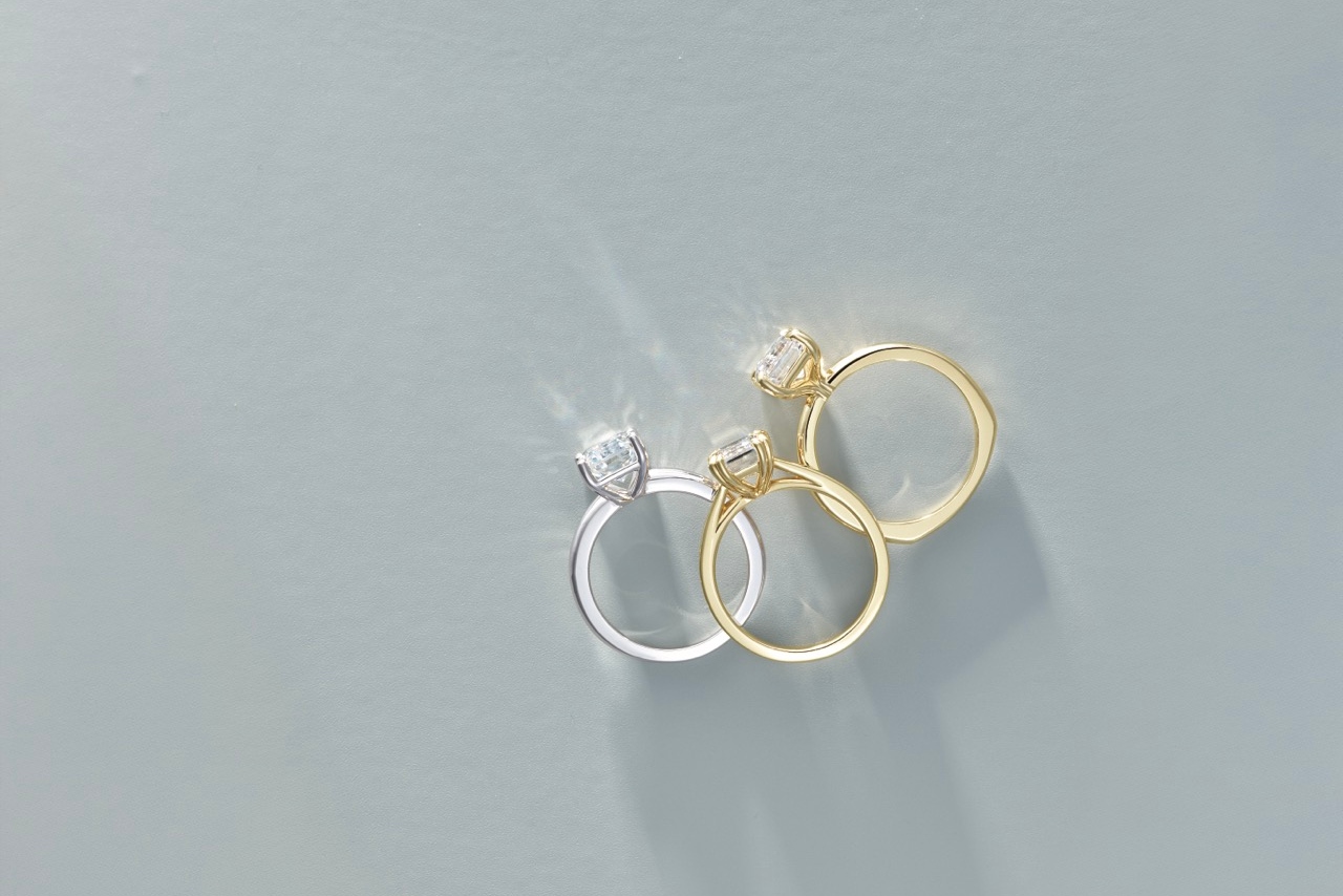  A bride placing a wedding ring on the groom’s finger during a wedding ceremony.