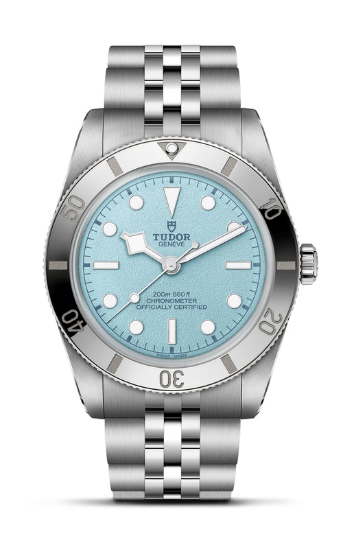 A TUDOR silver stainless steel watch featuring a light blue dial and a rotating bezel.