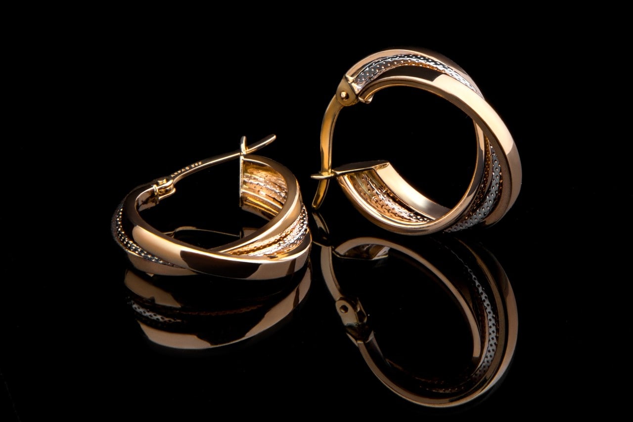 Multiple tones of gold in a pair of hoop earrings.