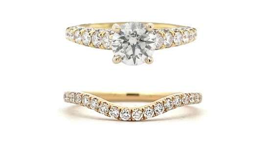 a yellow gold diamond engagement ring and a curved diamond wedding band