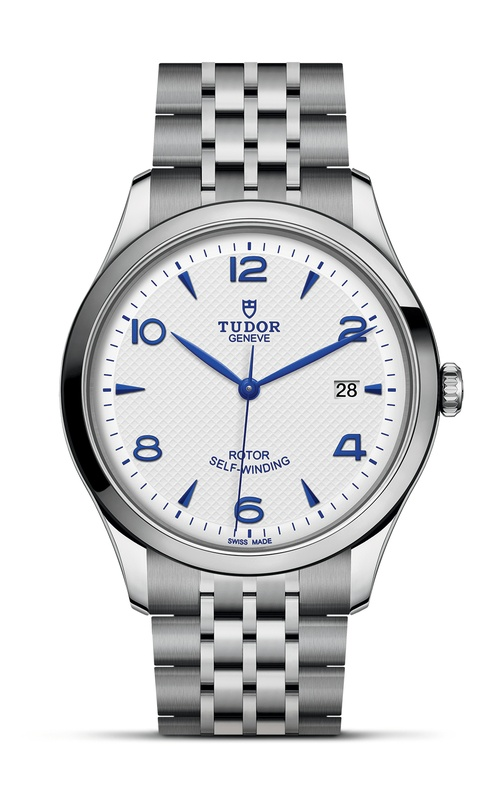 A TUDOR 1926 watch with blue arab numerals, white dial and stainless steel bracelet.