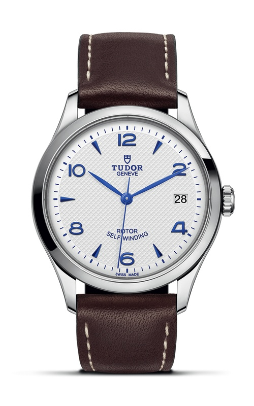 A TUDOR brown leather watch with white dial and deep blue hands and indexes.