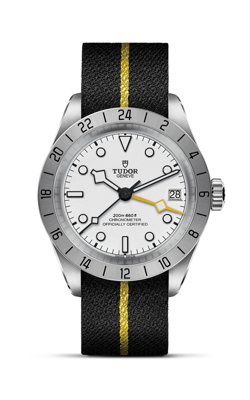 A TUDOR watch with white dial, black strap with yellow line, and rotating bezel