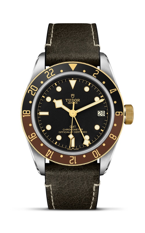 A TUDOR black leather wristwatch with black dial and gold plated bezel.