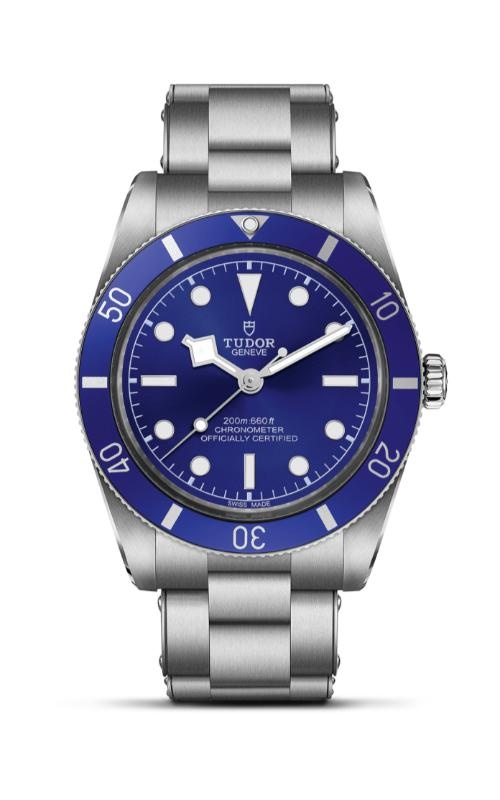 A TUDOR stainless steel watch with deep blue dial and rotating bezel.