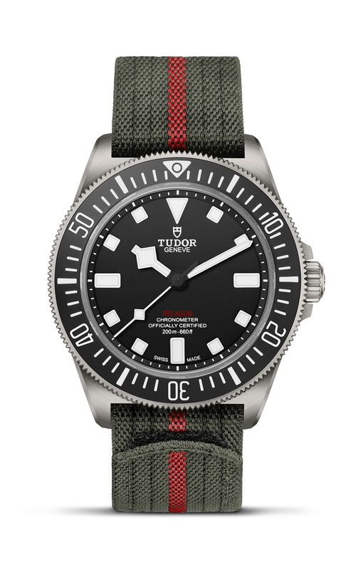 A TUDOR watch with a black dial, rotating bezel and a fabric green strap.