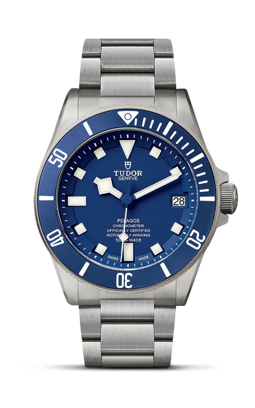 A TUDOR watch with a blue dial, rotating bezel, and stainless steel bracelet.