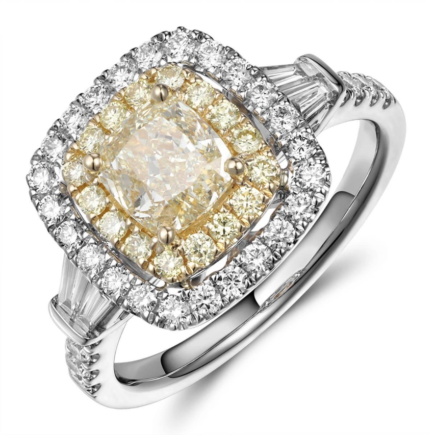 A mixed metal engagement ring with a yellow center diamond and double halo, available at Heller Jewelers.