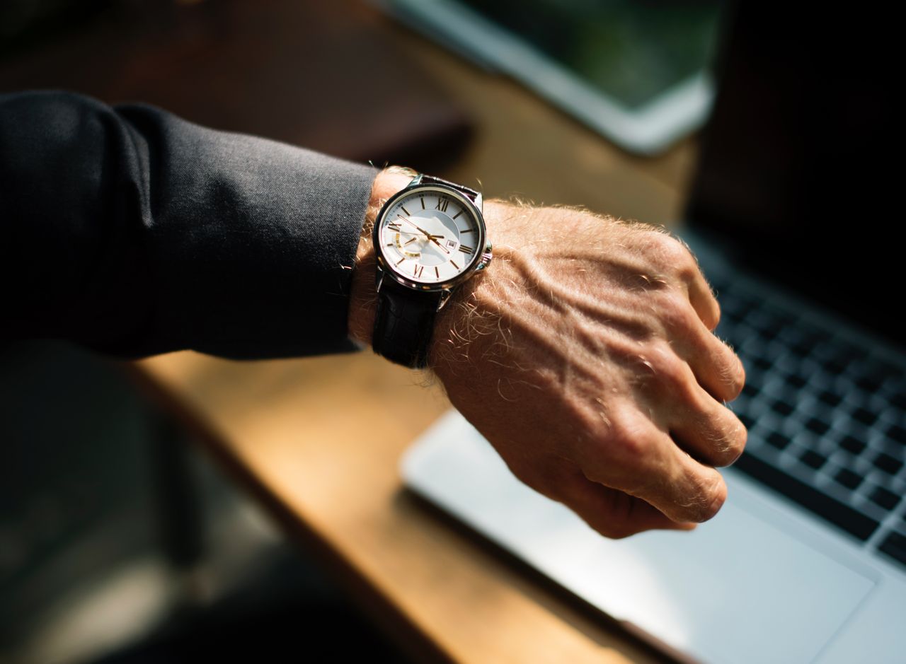 Guy, definitely a dad, checking the time.