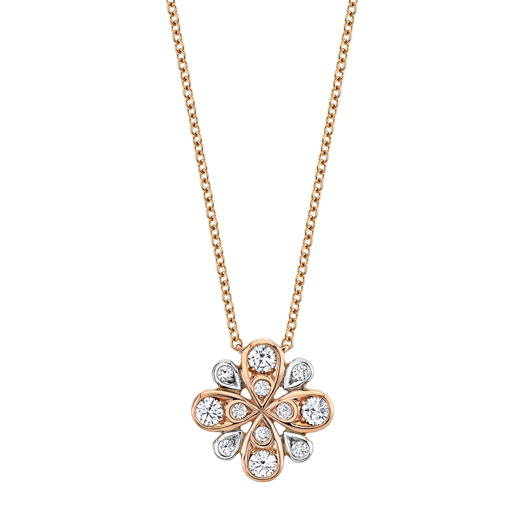 A rose gold flower shaped diamond necklace on a white background