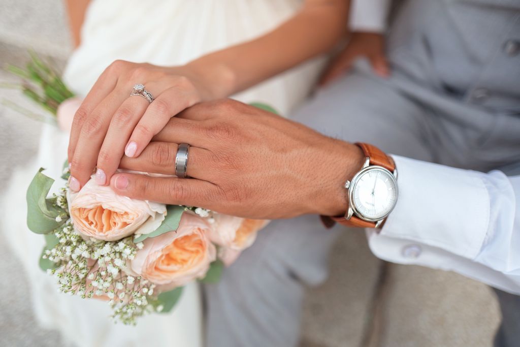 Man with a Tantalum ring holding hands with his new bride.