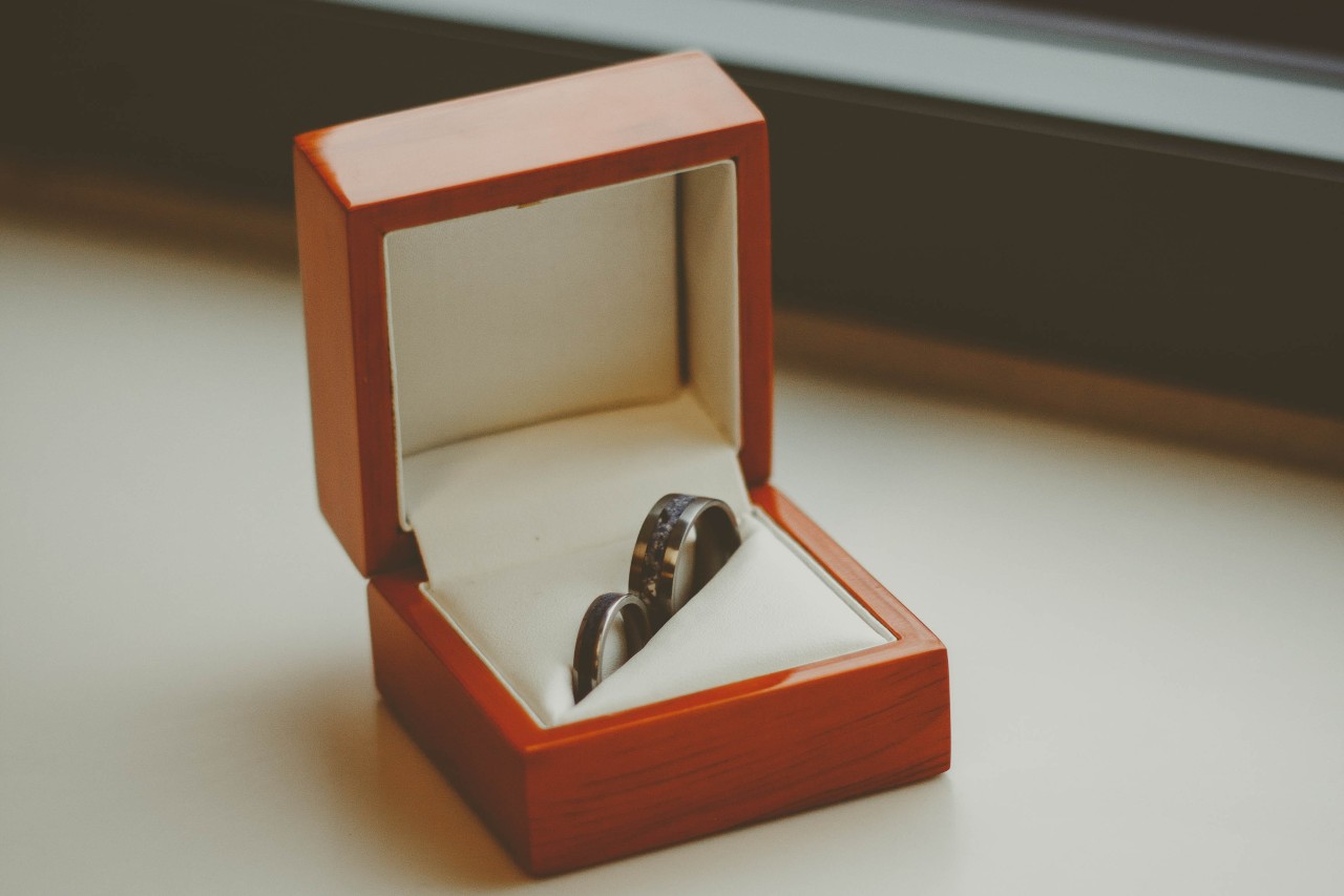 Tantalum wedding band alongside a slender band.