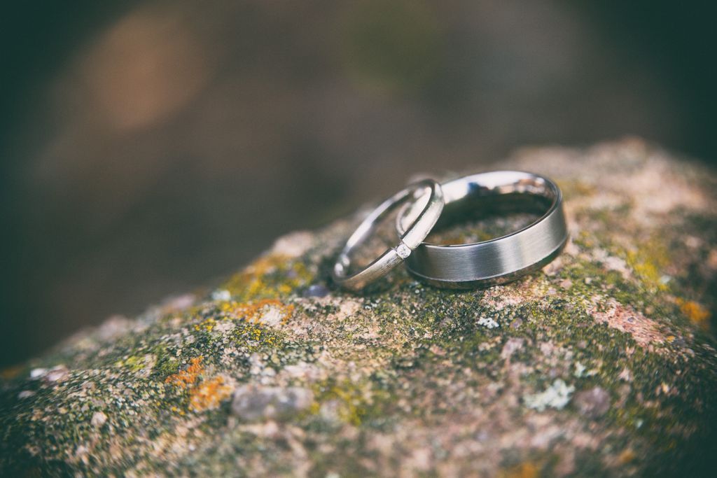 Marvelous wedding band setting atop a stone with an engagement ring balanced against it.