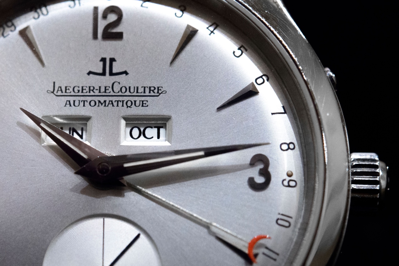 A close-up of a silver Jaeger-LeCoultre luxury watch face.