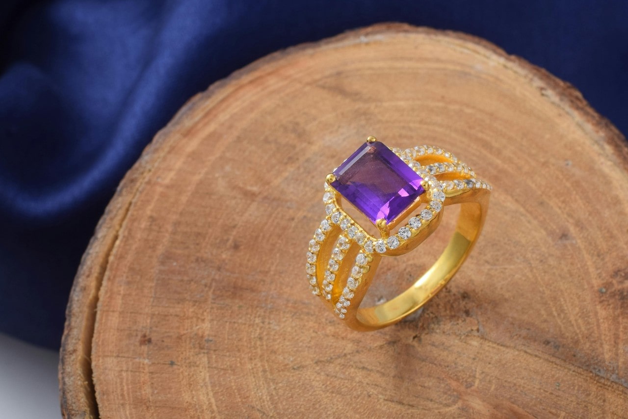 An exquisite sapphire gold ring on a wooden surface. An exquisite sapphire gold ring on a wooden surface.